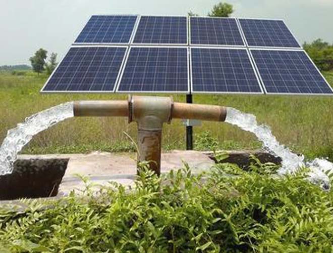 Solar-powered water pump installation in an open field